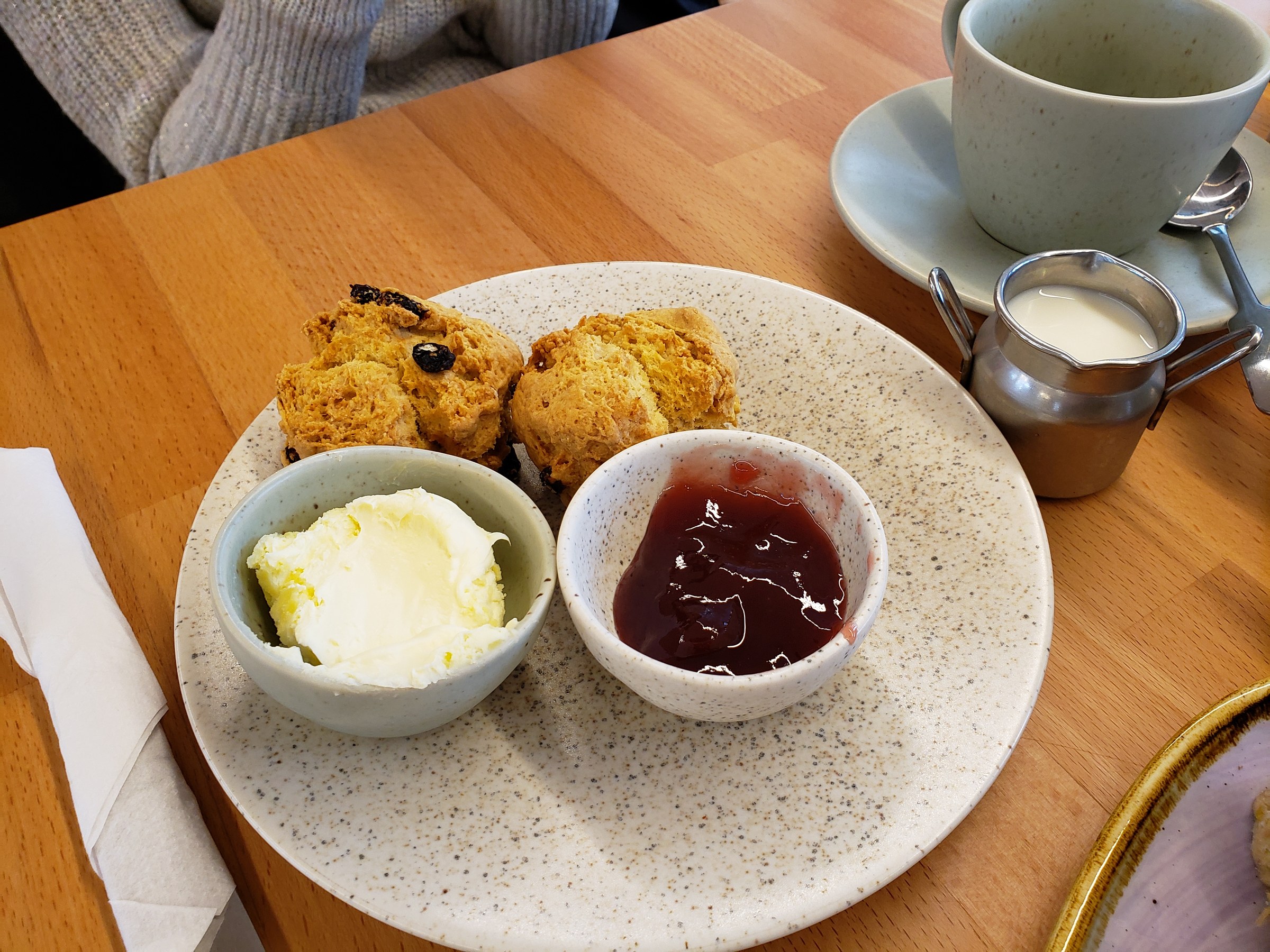 Scones with clotted cream and jam, served with a pot of tea